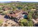 Aerial perspective highlighting desert home's private pool, putting green, and luxurious outdoor living spaces at 7413 E Lower Wash Pass, Scottsdale, AZ 85266