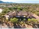 Desert home aerial view featuring manicured landscaping, desert foliage, and classic architecture at 7413 E Lower Wash Pass, Scottsdale, AZ 85266