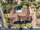 Aerial view showcases luxury desert home with private pool, spa, putting green, and beautiful tiled roof at 7413 E Lower Wash Pass, Scottsdale, AZ 85266