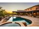 Stunning backyard with a pool, spa, outdoor kitchen, and covered patio at 7413 E Lower Wash Pass, Scottsdale, AZ 85266