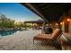 Spacious backyard with a luxurious pool, covered patio, and comfortable lounge seating at 7413 E Lower Wash Pass, Scottsdale, AZ 85266