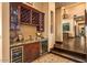 Custom bar area with wine storage, granite countertops, and a convenient sink at 7413 E Lower Wash Pass, Scottsdale, AZ 85266