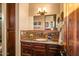 Bathroom featuring granite countertops, mosaic tile backsplash, and custom cabinetry, offering luxury and style at 7413 E Lower Wash Pass, Scottsdale, AZ 85266
