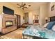 Spacious bedroom with a stone fireplace, king-size bed, and private outdoor access at 7413 E Lower Wash Pass, Scottsdale, AZ 85266