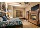 Bright bedroom with a stone fireplace, king-size bed, and private outdoor access at 7413 E Lower Wash Pass, Scottsdale, AZ 85266