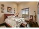 Cozy bedroom with a window offering a view of the desert landscape, creating a serene and relaxing atmosphere at 7413 E Lower Wash Pass, Scottsdale, AZ 85266