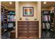 Spacious closet with dark wood cabinetry and organization, offering ample storage for clothing and accessories at 7413 E Lower Wash Pass, Scottsdale, AZ 85266