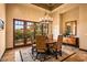 Elegant dining area featuring backyard views, wood table, decorative rug, and chandelier at 7413 E Lower Wash Pass, Scottsdale, AZ 85266