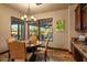 Cozy dining area with backyard views, a round wood table, leather chairs, and elegant lighting at 7413 E Lower Wash Pass, Scottsdale, AZ 85266