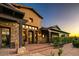 Lovely home exterior displaying unique architecture, an arched door, stone and stucco, and inviting front entrance at 7413 E Lower Wash Pass, Scottsdale, AZ 85266