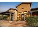 Lovely home displaying unique architecture, an arched front door, stone and stucco, and an inviting brick-paved entrance at 7413 E Lower Wash Pass, Scottsdale, AZ 85266