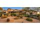 Expansive desert landscaping surrounds this beautiful home featuring stone accents and covered porch at 7413 E Lower Wash Pass, Scottsdale, AZ 85266