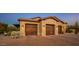Beautiful home garage displaying wooden doors and a paved drive with mature landscaping at 7413 E Lower Wash Pass, Scottsdale, AZ 85266
