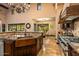 Chef's kitchen featuring granite countertops, a copper sink, and professional-grade appliances at 7413 E Lower Wash Pass, Scottsdale, AZ 85266