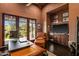 Home office with a leather chair, wooden desk, and a view of the outdoors, creating an inspiring workspace at 7413 E Lower Wash Pass, Scottsdale, AZ 85266