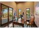 Bright home office with a view of the outdoors, a wooden desk, and natural light, perfect for working from home at 7413 E Lower Wash Pass, Scottsdale, AZ 85266