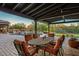 Outdoor patio with a dining table, chairs, pool and putting green, perfect for entertaining and enjoying the outdoors at 7413 E Lower Wash Pass, Scottsdale, AZ 85266