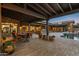 Inviting patio with a covered dining area and stone accents overlooking the pool at 7413 E Lower Wash Pass, Scottsdale, AZ 85266