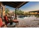 Serene outdoor area featuring a pool, spa, and stone waterfall feature at 7413 E Lower Wash Pass, Scottsdale, AZ 85266