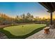 Backyard putting green with well-manicured turf and desert landscaping at 7413 E Lower Wash Pass, Scottsdale, AZ 85266