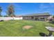 Expansive backyard with well-maintained lawn and patio perfect for outdoor entertaining at 8049 E Des Moines St, Mesa, AZ 85207