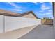 Private backyard has a white block wall and gate to an adjacent alley at 8049 E Des Moines St, Mesa, AZ 85207