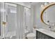 Stylish bathroom boasts a subway tile shower, modern vanity, and decorative mirror at 8049 E Des Moines St, Mesa, AZ 85207