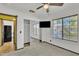 Sunny bedroom featuring neutral carpet, a mirrored closet, a ceiling fan, and a window view at 8049 E Des Moines St, Mesa, AZ 85207