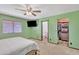 Large bedroom includes a queen bed, a ceiling fan, neutral carpet, and a spacious closet at 8049 E Des Moines St, Mesa, AZ 85207
