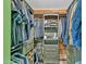 Walk-in closet featuring custom shelving and storage for optimal organization, keeping clothes neat at 8049 E Des Moines St, Mesa, AZ 85207