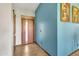 Inviting entryway featuring stylish door, wood-look tile flooring, and accent wall at 8049 E Des Moines St, Mesa, AZ 85207