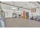 Spacious garage with epoxy floors, work bench and ample storage; door to utility room at 8049 E Des Moines St, Mesa, AZ 85207
