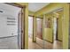 Hallway showcasing multiple closets, updated lighting, fresh paint, and wood-look floors at 8049 E Des Moines St, Mesa, AZ 85207