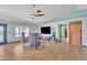 Open-concept living room boasting wood-look flooring, stylish furnishings, a ceiling fan, and modern updates at 8049 E Des Moines St, Mesa, AZ 85207