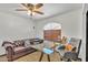 Bright office features a leather couch, glass desk, ceiling fan, and a sunlit arched window at 8049 E Des Moines St, Mesa, AZ 85207