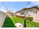 Landscaped backyard featuring artificial turf and a cozy seating area, perfect for relaxation and outdoor games at 8213 E Whitton Ave, Scottsdale, AZ 85251