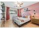 Stylish bedroom with a unique patterned pink accent wall, metal bed frame, and decor at 8213 E Whitton Ave, Scottsdale, AZ 85251
