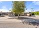 Charming single-story home showcasing a well-kept front yard, mature landscaping, and covered parking at 8213 E Whitton Ave, Scottsdale, AZ 85251