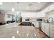 Modern kitchen featuring granite countertops, stainless steel appliances, and ample cabinet space with a view of a recreation room at 8213 E Whitton Ave, Scottsdale, AZ 85251