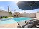 Backyard pool featuring lounge chairs, cabana bar, and pristine landscaping, perfect for outdoor relaxation and entertaining at 8213 E Whitton Ave, Scottsdale, AZ 85251