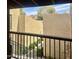 Balcony view overlooking the lush landscaping and walkways of the complex, offering a serene outdoor living experience at 8302 N 21St Dr # L204, Phoenix, AZ 85021