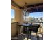 Charming balcony with a chandelier, table, seating, and beautiful neighborhood views at 8302 N 21St Dr # L204, Phoenix, AZ 85021