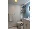 A well-lit powder room showcasing modern fixtures, vanity, and stylish blue accent wall for added charm at 8302 N 21St Dr # L204, Phoenix, AZ 85021