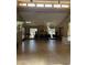 A view of the common room featuring high ceilings, tile floors and large windows at 8302 N 21St Dr # L204, Phoenix, AZ 85021
