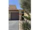 Beige townhome with brown garage door, red tile roof, and tidy landscaping at 8302 N 21St Dr # L204, Phoenix, AZ 85021