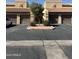 A close exterior shows a two-story townhouse with brown garages and xeriscaping at 8302 N 21St Dr # L204, Phoenix, AZ 85021