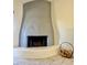 Modern gray fireplace with decorative log storage on the floor, complemented by tiled flooring at 8302 N 21St Dr # L204, Phoenix, AZ 85021