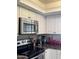 A modern kitchen has stainless steel appliances, white cabinets and stone countertops at 8302 N 21St Dr # L204, Phoenix, AZ 85021