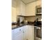 Well-equipped kitchen with stainless steel appliances, including a stove, microwave, and a toaster, set against a neutral backsplash at 8302 N 21St Dr # L204, Phoenix, AZ 85021