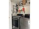Laundry area featuring a modern washer and dryer set with convenient shelving for storage and organization at 8302 N 21St Dr # L204, Phoenix, AZ 85021